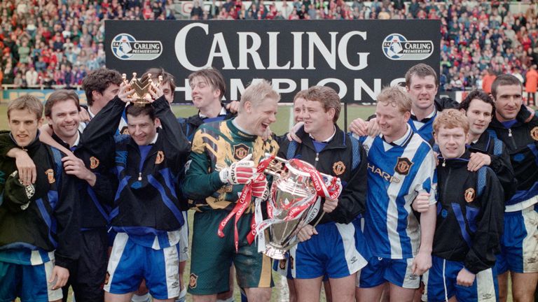 Manchester United captain Steve Bruce (c) and goalkeeper Peter Schmeichel celebrate with team mates and the premiership trophy after winning the 1995/96