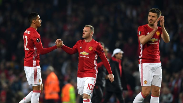MANCHESTER, ENGLAND - MAY 11: Wayne Rooney and Chris Smalling of Manchester United speak following the UEFA Europa League, semi final second leg match, bet