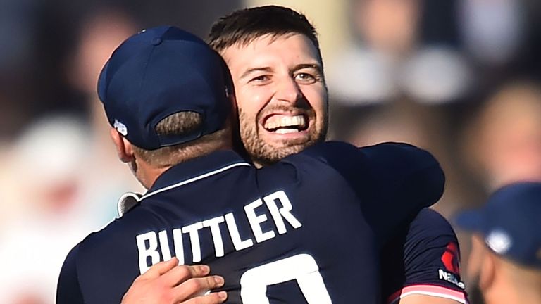 Mark Wood celebrates with Jos Buttler after bowling England to victory