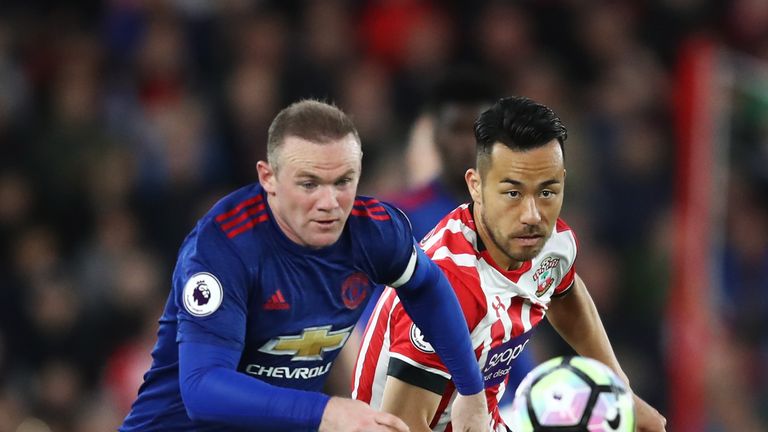 Wayne Rooney of Manchester United is put under pressure from Maya Yoshida of Southampton during the Premier League match