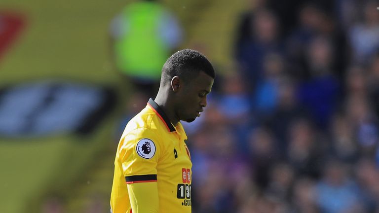 WATFORD, ENGLAND - MAY 21:  M'Baye Niang of Watford picks up a bird from the pitch during the Premier League match between Watford and Manchester City at V