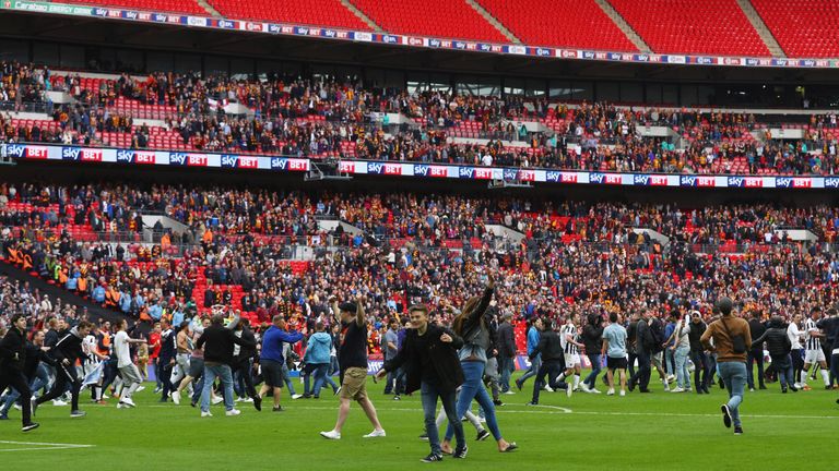 LONDON, ENGLAND - MAY 20:  Millwall fans invade the pitch in celebration after the Sky Bet League One Playoff Final between Bradford City and Millwall at W