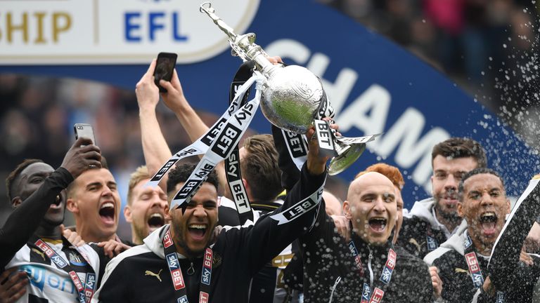 Jamaal Lascelles of Newcastle United (L) and Jonjo Shelvey of Newcastle United (R) celebrate with the Championship Trophy