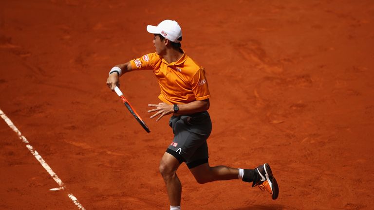 MADRID, SPAIN - MAY 11:  Kei Nishikori of Japan in action against David Ferrer of Spain during day six of the Mutua Madrid Open tennis at La Caja Magica on