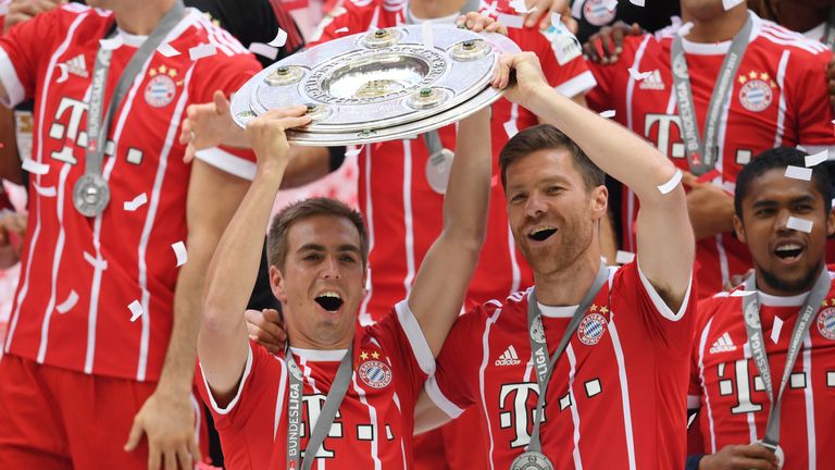 Philipp Lahm and Xabi Alonso lift the Bundesliga trophy after their final game in club football