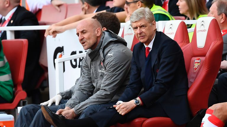 Arsene Wenger cuts a dejected figure in the dugout at the Emirates Stadium