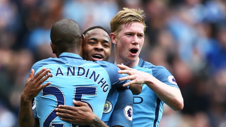 Raheem Sterling is congratulated by Fernandinho and Kevin De Bruyne after extending Manchester City's lead