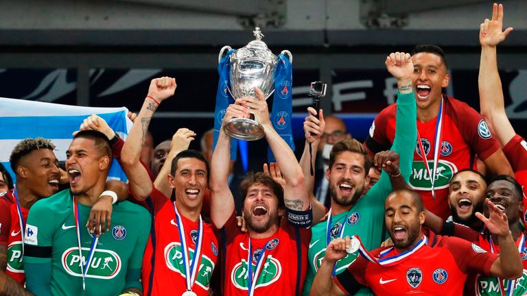 Paris Saint-Germain's Brazilian defender Maxwell (C) holds the trophy as he celebrates winning the French Cup final football match between Paris Saint-Germ