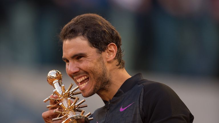 Rafael Nadal of Spain celebrates with the trophy after the Madrid final