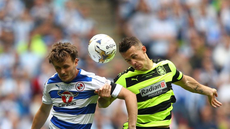 Reading's John Swift of Reading and Jonathan Hogg of Huddersfield Town battle to win the ball