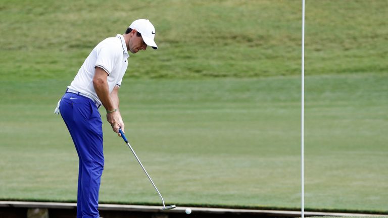 Rory McIlroy of Northern Ireland putts left-handed on the fourth green during the third round of THE PLAYERS Championship 