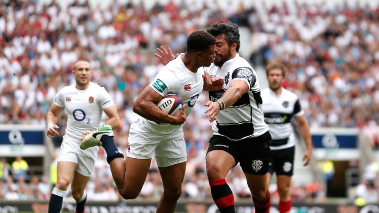 England's Nathan Earle is tackled by Barbarians Yann David at Twickenham