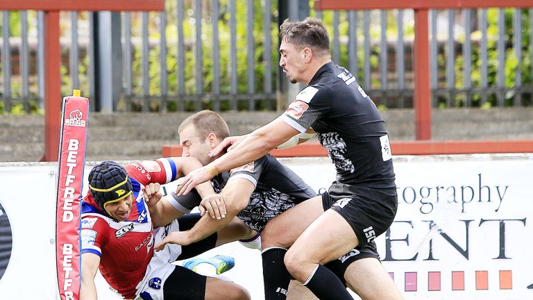 Ben Jones-Bishop scores a try against Catalans despite the efforts of Iain Thornley and Tony Gigot