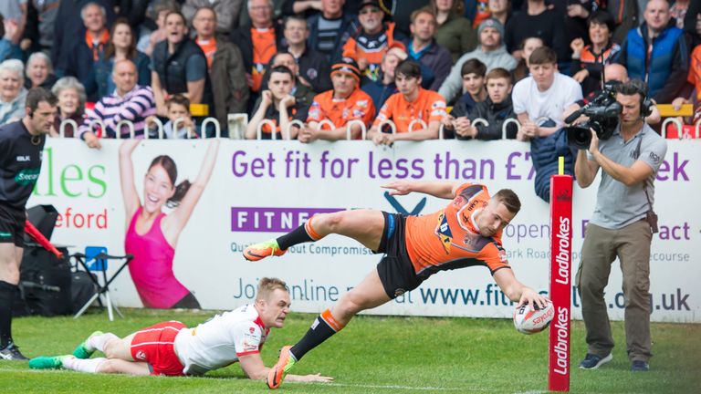 St Helens's Adam Swift is unable to prevent Greg Eden from scoring a try