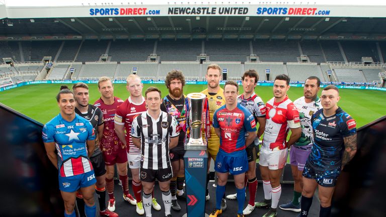 12 Super League representatives pose with the Betfred Super League trophy ahead of the Dacia Magic Weekend at St James's Park