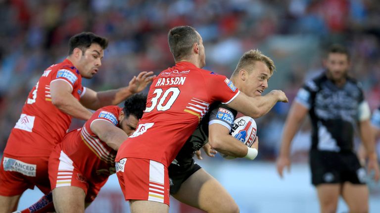 Paul Seguir is tackled by Salford's James Hasson (30)