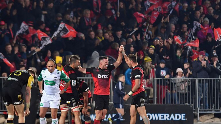 Ryan Crotty (middle) leads the celebrations after the Crusaders' win over the Hurricanes