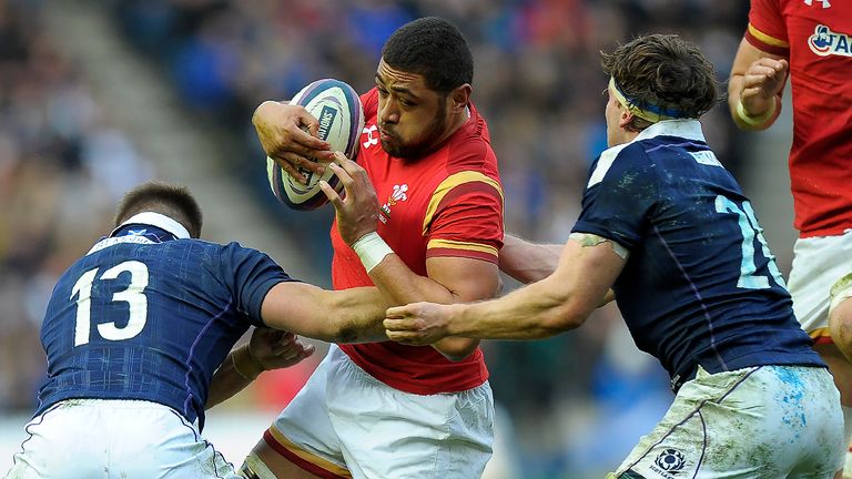 Taulupe Faletau is tackled by Huw Jones (L) and Hamish Watson during the Six Nations match at Murrayfield