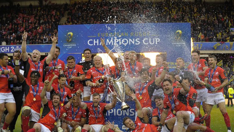 The champagne is sprayed as Saracens celebrate their win with the trophy on the pitch after the rugby union European Champions Cup Final in 2017