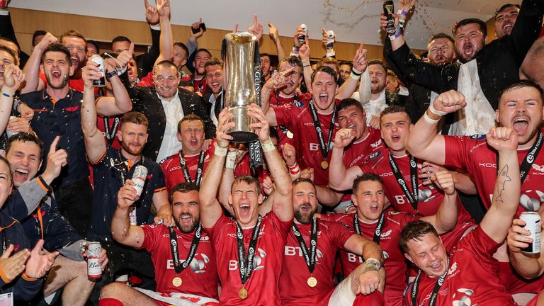 Scarlets celebrate with the trophy.