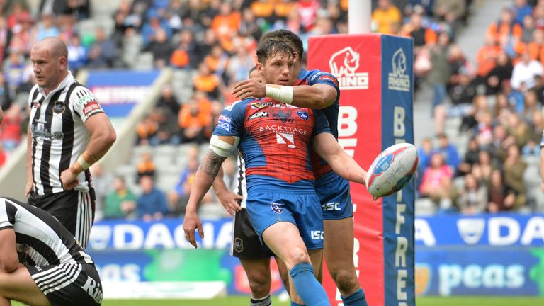Wakefield Trinity's Scott Grix celebrates after scoring a try against Widnes