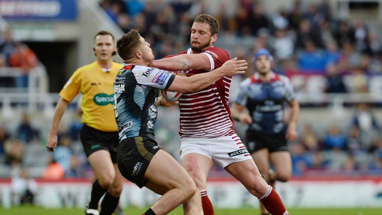 Wigan Warriors Sean O'Loughlin (right) is tackled by Warrington Wolves' Tom Lineham
