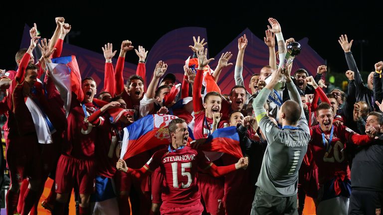 Serbia players celebrate with the trophy after the FIFA Under-20 World Cup football final match between Brazil and Serbia in Auckland on June 20, 2015.? AF