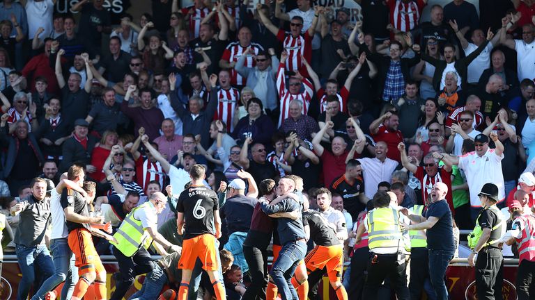 NORTHAMPTON, ENGLAND - APRIL 08: Sheffield United fans invade the pitch after leon Clarke had scored his sides first goal during the Sky Bet League One mat