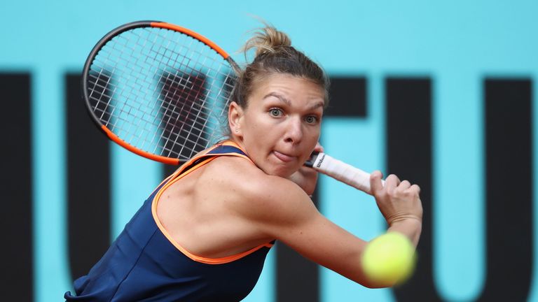 Simona Halep of Romania plays a backhand in her match against Samantha Stosur of Australia during day five of the Mutua Madrid Open