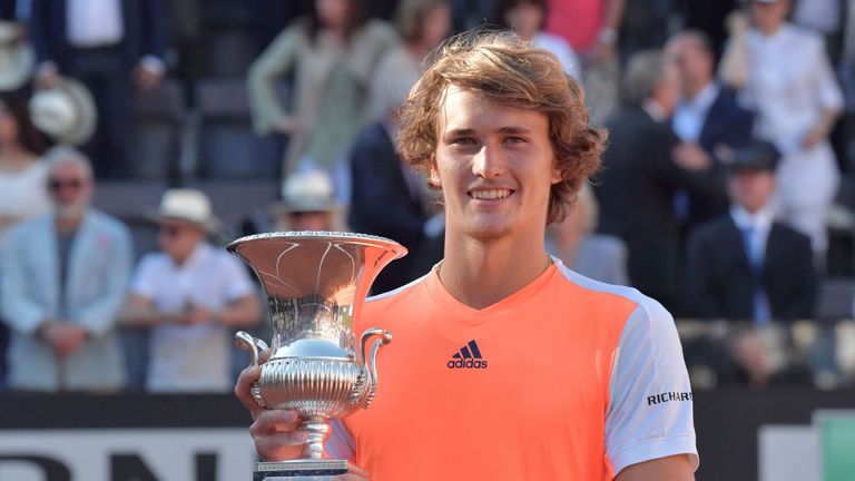 Alexander Zverev of Germany poses with the trophy after winning the ATP Tennis Open final against Novak Djokovic