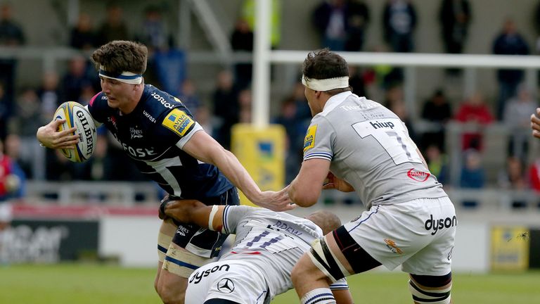 Tom Curry (left) of Sale Sharks tackled by Bath's Aled Brew