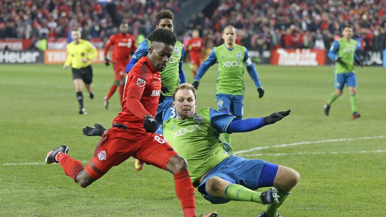 TORONTO, ONTARIO - DECEMBER 10:  Chad Marshall #14 of the Seattle Sounders looks to make a play against Tosaint Ricketts #87 of the Toronto FC during the 2