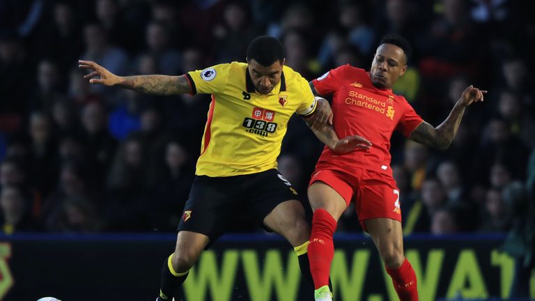 Troy Deeney is challenged by Liverpool defender Nathaniel Clyne 