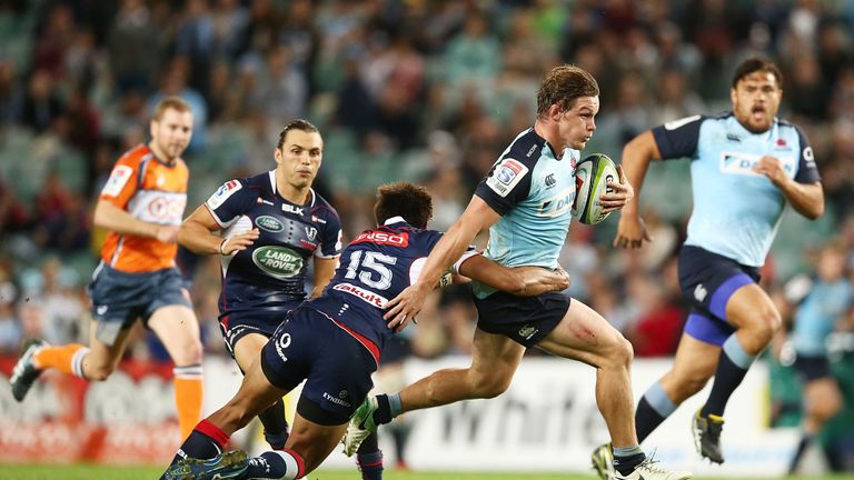 Michael Hooper of the Waratahs is tackled during the round 13 Super Rugby match between the Waratahs and the Rebels at Allianz