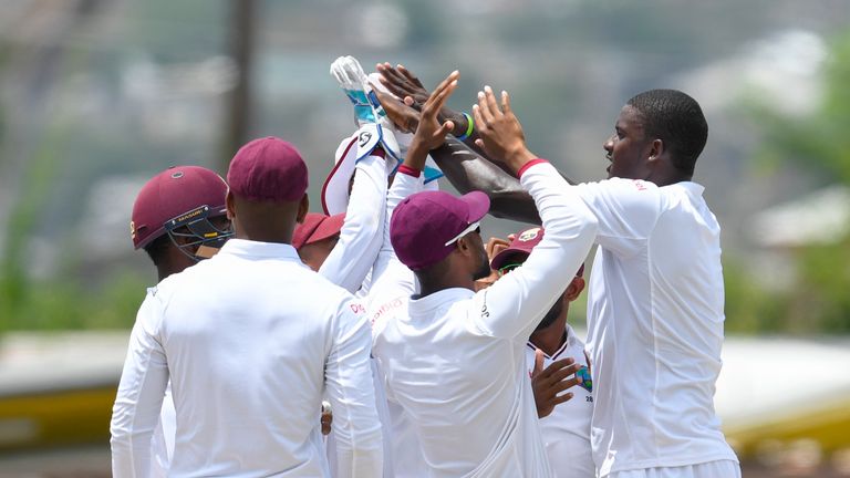 Jason Holder (R) of West Indies celebrates the dismissal of Shadab Khan of Pakistan during the 5th and final day of the 2nd Test match between West Indies 