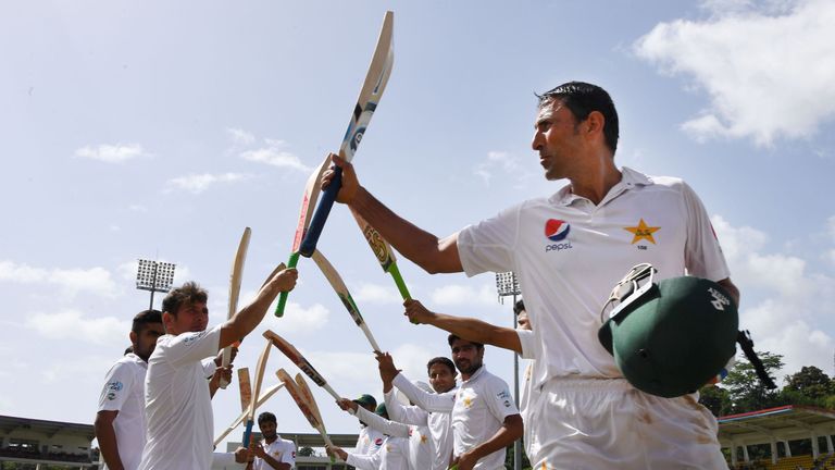 Members of the Pakistan team form a honor guard for Younis Khan after his dismissal