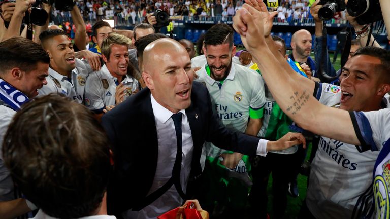 MALAGA, SPAIN - MAY 21:  Zinedine Zidane, Manager of Real Madrid celebrates with his players after being crowned champions following the La Liga match betw