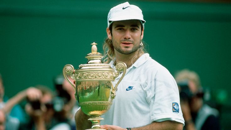 Andre Agassi celebrates with the trophy after the Wimbledon final 