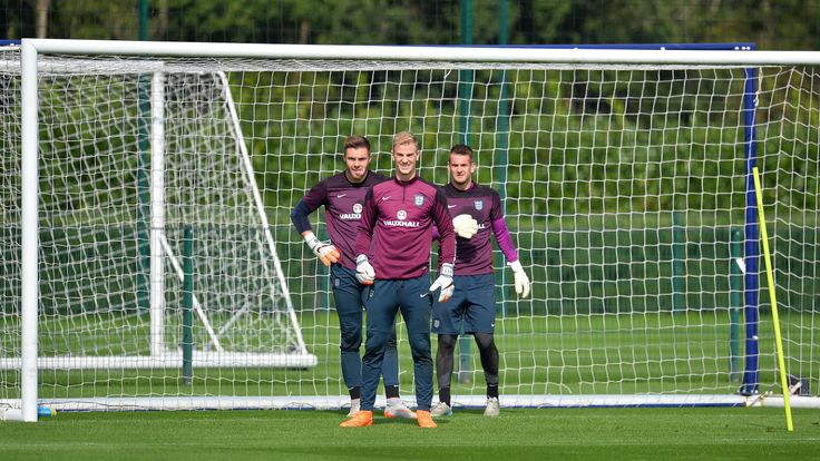 England goalkeeper Jack Butland (L), goalkeeper Joe Hart (C) and goalkeeper Tom Heaton stand in a goal during a team training session at Tottenham Hotspur 