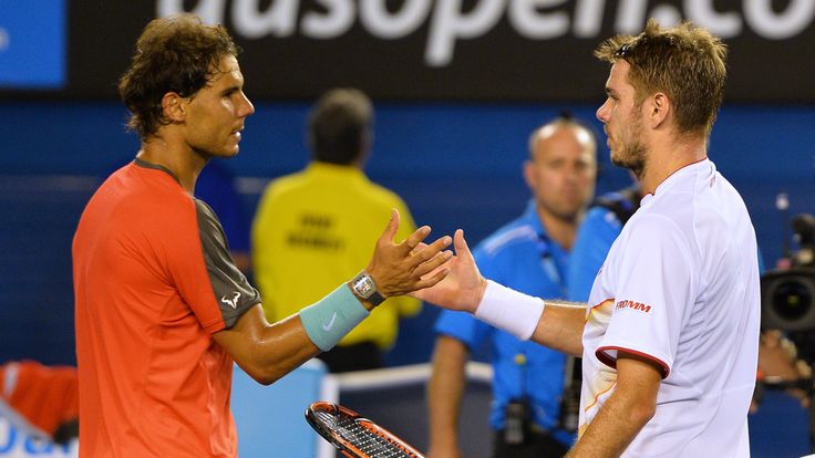 Switzerland's Stan Wawrinka (R) shakes hands with Spain's Rafael Nadal after his victory during the men's singles final of the 2014 Australian Open