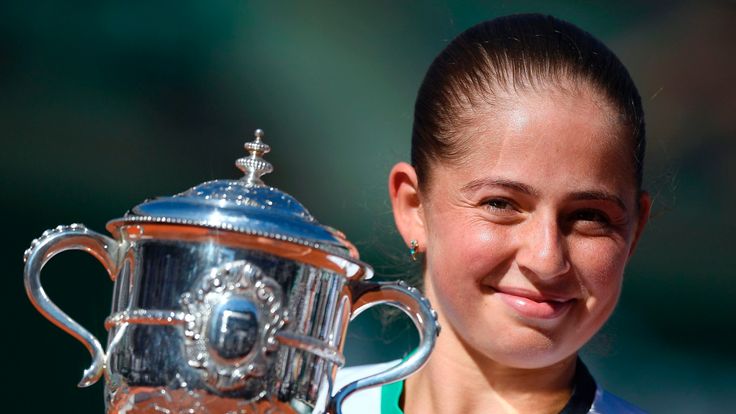 Latvia's Jelena Ostapenko celebrates with her trophy after winning her final tennis match against Romania's Simona Halep at the 2017 French Open