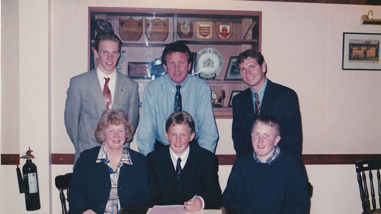 Tom Youngs signs his first professional contract as Cambridge United manager Roy McFarland looks on [Credit: Tom Youngs]