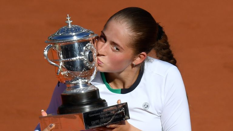 Latvia's Jelena Ostapenko poses with the trophy after winning against Romania's Simona Halep during their final tennis match at the Roland Garros 2017 Fren