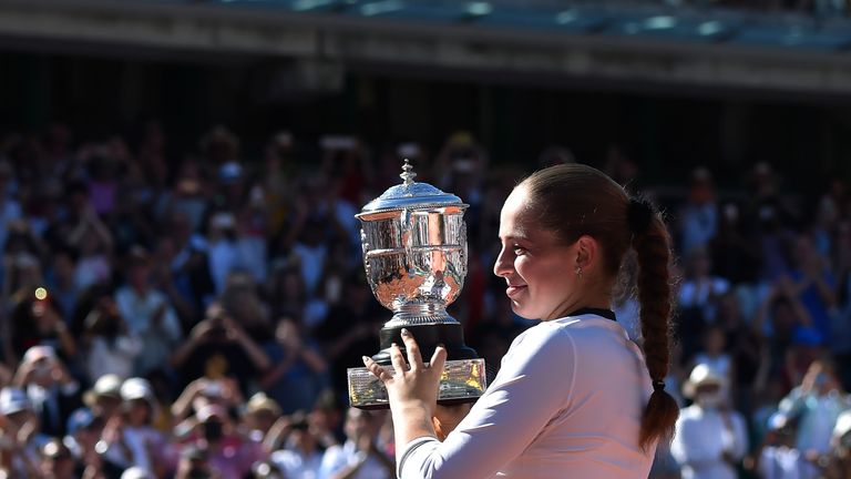 Latvia's Jelena Ostapenko celebrates with her trophy after winning her final tennis match against Romania's Simona Halep at the Roland Garros 2017 French O