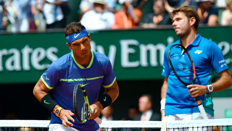 Switzerland's Stanislas Wawrinka looks on next to Spain's Rafael Nadal during the men's final tennis match at the Roland Garros 2017 French Open on June 11