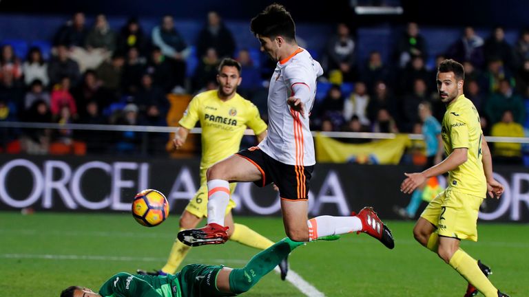 Villarreal's goalkeeper Sergio Asenjo (L) falls past Valencia's Carlos Soler during a Spanish Primera Liga match
