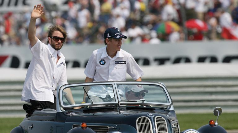 Indianapolis, UNITED STATES: German BMW-Sauber drivers Nick Heidfeld (L) and Sebastian Vettel wave to the crowd before the United States Grand Prix at Indi