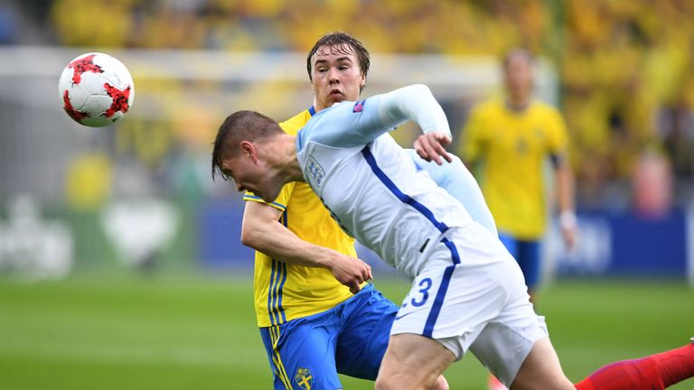 Sweden U21s' Simon Tibbling (L) and England Under-21s' Alfie Mawson vie for the ball during the UEFA European U21 Championship match