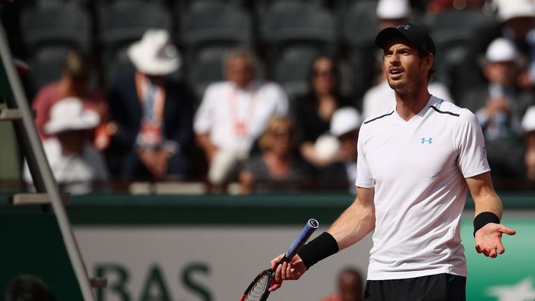 Andy Murray protests with umpire Carlos Ramos after receiving a time penalty