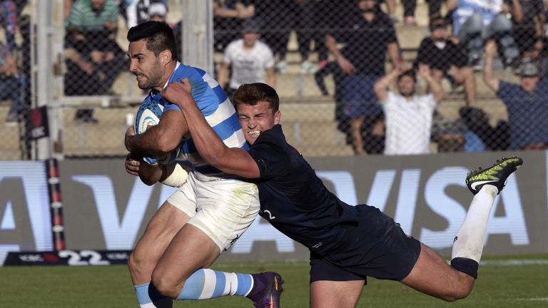 Jeronimo De La Fuente (L) runs through a tackle by Henry Slade to score a try 